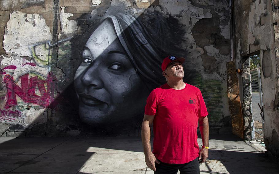 Jerry “Lij” Britton stands inside the shell of an old newspaper building on Oct. 6, 2022, in front of a mural of his missing daughter, Khadijah Britton, who was last seen Feb. 8, 2018 while being forced into a car at gunpoint by ex-boyfriend Negie Fallis in Covelo, California. 