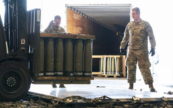 FILE - Airmen with the 436th Aerial Port Squadron place 155 mm shells on aircraft pallets ultimately bound for Ukraine, April 29, 2022, at Dover Air Force Base, Del. Half of the people in the U.S. support the Pentagon's ongoing supply of weapons to Ukraine for its defense against Russian forces. That's according to a new survey by the University of Chicago's Harris School of Public Policy and NORC. (AP Photo/Alex Brandon, File)