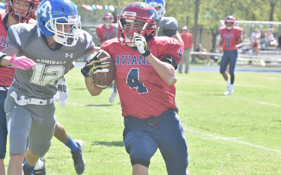 Aviano running back Patrick Romanazzi carried the ball 12 yards to set up the game's first touchdown Saturday, Sept. 10, 2022, before Rota's Jordan Cully could bring him down.
