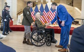 Sgt. Joseph J. Drake, center, is greeted by Secretary of Defense Pete Hegseth on Thursday, June 26, 2025, in Washington during a Congressional Gold Medal ceremony honoring U.S. Army Ranger veterans of World War II in Emancipation Hall at the U.S. Capitol.
(Eric Kayne/Stars and Stripes)