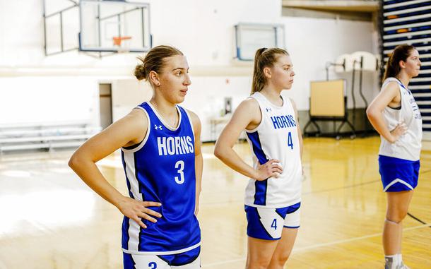 This photo provided by the University of Lethbridge shows Ukrainian nationals Vlada Hozalova (3) and Vika Kovalevska (4) on the court during basketball practice at the University of Lethbridge, in Lethbridge, Alberta,  Monday, Oct. 3, 2022. Kovalevska and Hozalova have found brief sanctuary from the war in their homeland playing for the University of Lethbridge. The pair fled their Ukrainian homes and arrived in Canada in May. Kovalevska and Hozalova are friends who have played internationally for Ukraine’s under-20 women’s team.  (Leslie Ohene-Adjei/University of Lethbridge via AP)