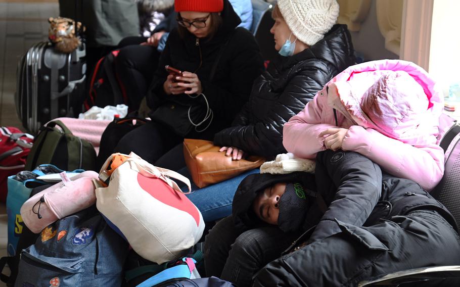 Exhausted from their journey, refugees from Ukraine rest inside the train station at Przemysl, Poland, March 2, 2022. According to the United Nations, more than 1 million people have fled Ukraine in a week’s time.