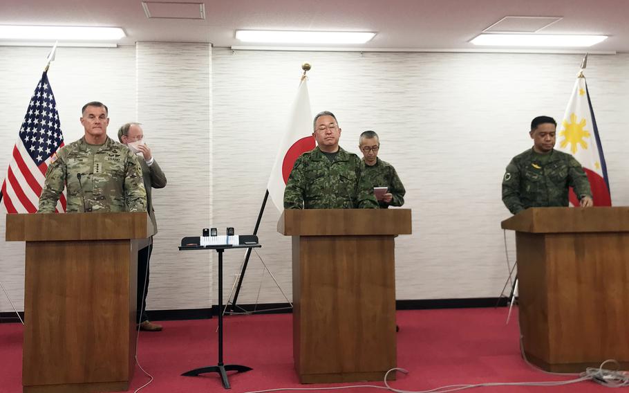 U.S. Army Pacific commander Gen. Charles Flynn, left, Japan Ground Self-Defense Force commander Gen. Yoshihide Yoshida, center, and Philippine army commander Lt. Gen. Romeo Brawner speak to reporters at Camp Asaka, Japan, Sunday, Dec. 11, 2022. 