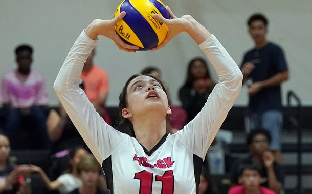 Nile C. Kinnick's Sophia Laron sets against Robert D. Edgren during Friday's DODEA-Japan volleyball match. The Red Devils won in straight sets.