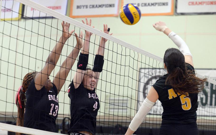 American School In Japan's Brianne Roberts spikes against Robert D. Edgren's Genesis Miller and Milan Bean during Thursday's pool-play match in the Ryukyu Island Tournament. The Eagles won in straight sets.