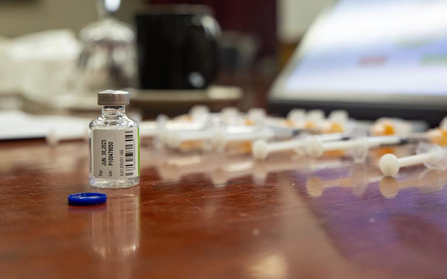 Influenza vaccines and COVID-19 shots are prepared on Marine Corps Base Camp Lejeune, N.C., in November 2022. In Europe, flu vaccine has been readily available to personnel linked to the U.S. military, but the latest COVID-19 booster shots are sporadically available on the Continent.