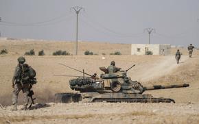 FILE - Turkish tanks and troops are deployed near the Syrian town of Manbij, Syria, Oct. 15, 2019. Hardly a day passes in northern Syria without Kurdish fighters and opposition gunmen backed by Turkey exchanging gunfire and shelling and concerns are rising that the situation will only get worse in the coming weeks with Ankara threatening to launch a new major operation along its southern border. (Ugur Can/DHA via AP, File)