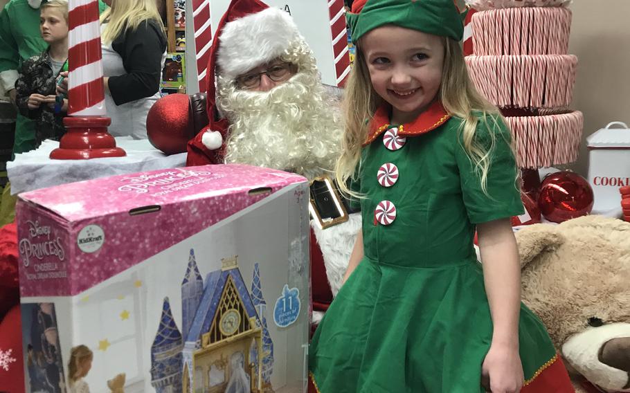 Harper Kelley shows Santa her new dollhouse at the 2019 4-H Toy Giveaway. 