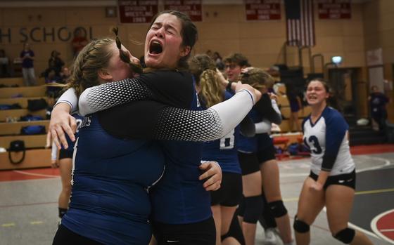 Brussels Brigand Patricia Rullan, right, shares an joyous embrace with teammate Nora Gibbons celebrating their win against the Sigonella Jaguars at the DODEA Division III European volleyball championship on Oct. 27, 2023, in Kaiserslautern, Germany.