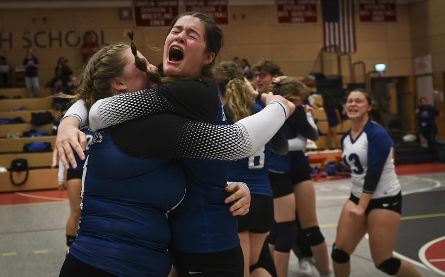 Brussels Brigand Patricia Rullan, right, shares a joyous embrace with teammate Nora Gibbons celebrating their win against the Sigonella Jaguars at the DODEA Division III European volleyball semifinals on Oct. 27, 2023, in Kaiserslautern, Germany.