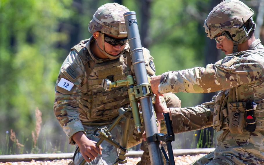 A mortar team from the Army National Guard sets up their 60mm mortar during the second day of the U.S. Army’s Best Mortar Competition at Fort Benning, Ga., on Tuesday, April 11, 2023. 