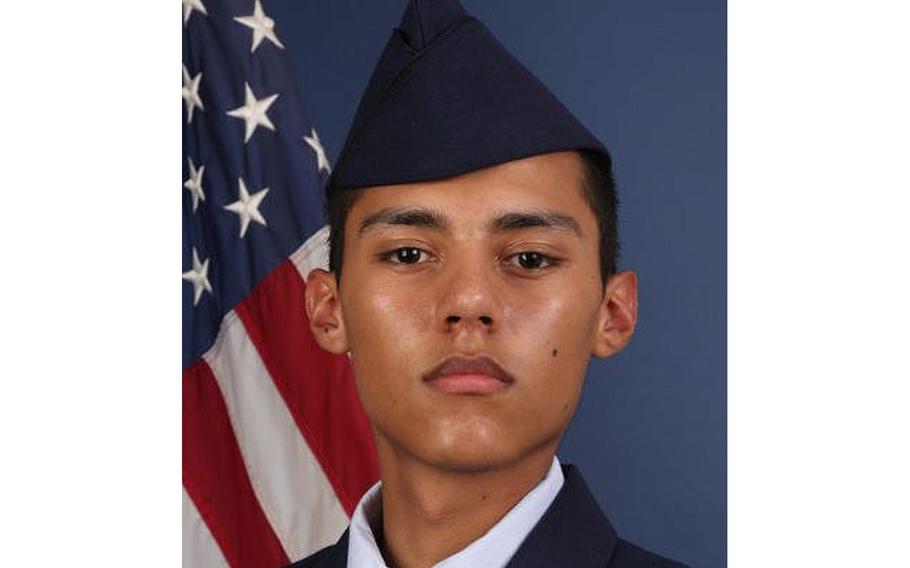 Photo of Senior Airman Joshua Aragon in his Air Force uniform from the neck up, wearing a cap and with an American flag behind his right shoulder.