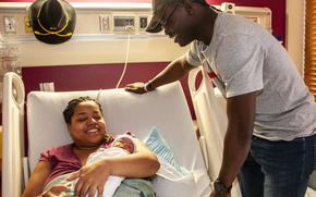 Pvt. Yolando Moton, a cavalry scout with 4th Battalion, 17th Infantry Regiment, 1st Brigade Combat Team, 1st Armored Division, smiles with wife, Christina Dixon-Moton, and newborn daughter, Ella Rose, during their postpartum stay at William Beaumont Army Medical Center, Feb. 26. A recent U.S. Army directive has extended leave opportunities for primary and secondary caregivers, more than doubling the amount of time off after the birth or adoption of an eligible beneficiary.