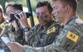 U.S. Army Staff Sgt. Thomas Schneider, center, assigned to U.S. Army Southern European Task Force, Africa, and his squad call for support in a fire lane during the U.S. Army Europe and Africa Best Squad competition at Grafenwoehr Training Area, Germany, Aug. 10, 2022.