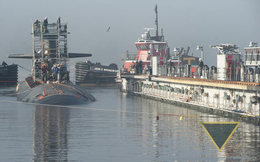 The Los Angeles class fast-attack submarine USS Newport News (SSN 750) is guided into the floating dry dock, ARDM 4, October 15, 2020 at Naval Submarine Base New London in Groton.