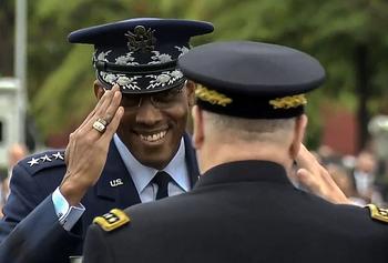 A video screen grab shows Incoming Joint Chiefs of Staff Chairman Air Force Gen. “CQ” Brown saluting the outgoing JCS chairman retiring Army Gen. Mark Milley.