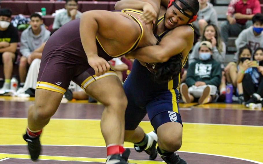 Guam High freshman Joaquin Gogue uses a cow-catcher hold to haul down Father Duenas Memorial's Aiden Mendiola in the heavyweight division of the Guam all-island wrestling tournament. Gogue won by pin and took the tournament's MVP award.