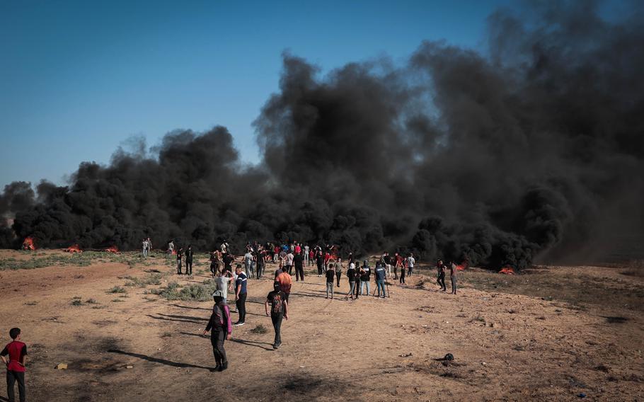 Palestinian demonstrators burn rubber tires along the border fence east of Gaza City on Friday, Sept. 15, 2023.