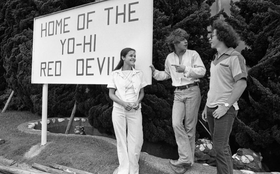 Mark Hamill, of Star Wars fame, chats with Melanie Shriver (18) and an unidentified student in front of a sign cheering on the Red Devils, the sports team of Nile C. Kinnick High School. 
