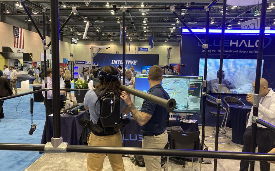 Virtual training was a big topic at the Space & Missile Symposium in Huntsville, Ala., this week. Here, a symposium attendee tries his hand at using a shoulder-mounted missile to take out virtual opposition at the Blue Halo booth.