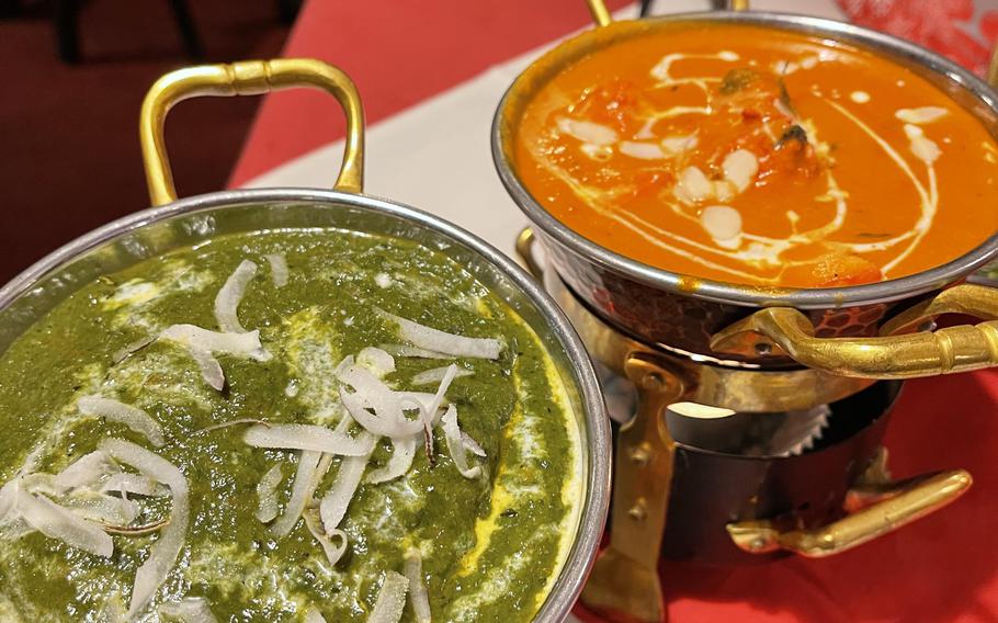 Ganesha's lamb nilgiri, left, shown with a curry with spinach and coconut milk served medium hot.  Butter chicken, straight, simmer in a tomato curry sauce.