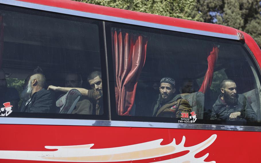 Freed prisoners sit inside a bus