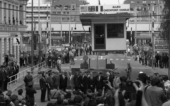 Berlin, Germany, June 22, 1990: Dignitaries stand in front of Checkpoint Charlie as the historic guard post is being removed by a crane. The site of many daring escapes, one infamous showdown between U.S. and Soviet forces in 1961, and immortalized in hundreds of spy novels and films, the small guard house was the only gateway where East Germany allowed Allied diplomats, military personnel, and foreign tourists to pass into Berlin’s Soviet sector. Looking for Stars and Stripes’ articles on the Cold War? Subscribe to Stars and Stripes’ historic newspaper archive! We have digitized our 1948-1999 European and Pacific editions, as well as several of our WWII editions and made them available online through http://starsandstripes.newspaperarchive.com/ META TAGS: Europe; DDR; BRD; Cold War; Berlin Wall;