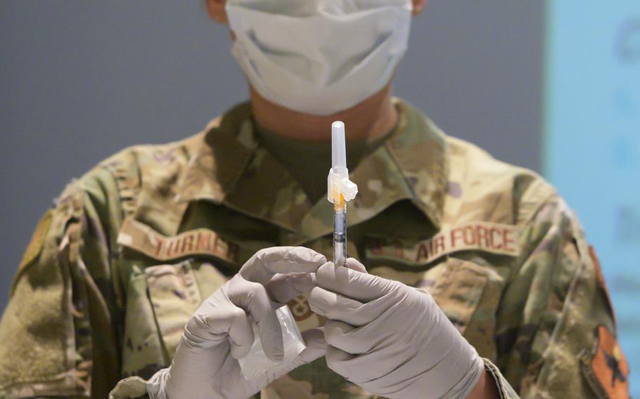 U.S. Air Force Tech. Sgt. Allison Turner, 88th Healthcare Operations Squadron, fills a syringe with the COVID-19 vaccine Jan 8, 2021, at Wright-Patterson Air Force Base, Ohio.