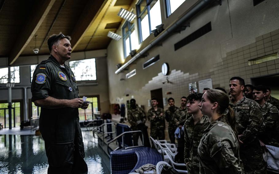 German air force Col. Michael Trautermann greets U.S. airmen and soldiers at the Ramstein Aquatic Center pool before they begin the swim portion of the German Armed Forces Badge for Military Proficiency, April 22, 2024, at Ramstein Air Base, Germany.