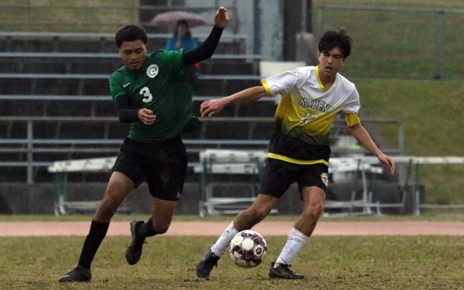 Kubasaki's Donovan Bias and Kadena's Will Wetherill chase the ball during Wednesday's Okinawa boys soccer match. The Panthers won 3-2.