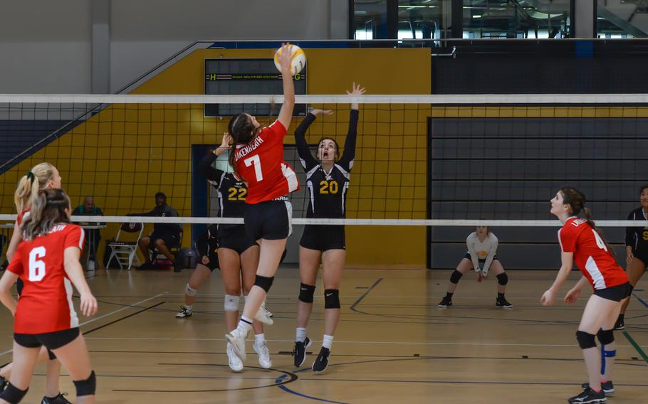 Lakenheath Lancer Riley Kraft spikes the ball across the net as Stuttgart's Berea Brian, left, and Ainsley Baker attempt to block her shot, Thursday, Oct. 27, 2022, at Ramstein Air Base, Germany.