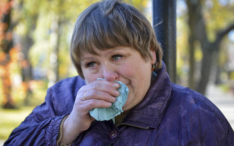 Valentina, a 50-year-old resident of Kyiv, Ukraine, cries while thinking of the Russian invasion of her country in early 2022. Valentina, who declined to provide her last name, came to Taras Shevchenko Park to gather water after a Russian missile attack struck critical energy and water facilities on Oct. 31, 2022.