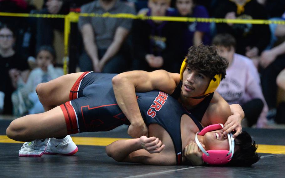 Vicenza’s Diego Cerda looks towards the referee as he has Kaiserslautern’s Joshua Kim in his grip, on the way to winning the 126-pound title at the DODEA-Europe wrestling finals in Wiesbaden, Germany, Feb. 10, 2024.