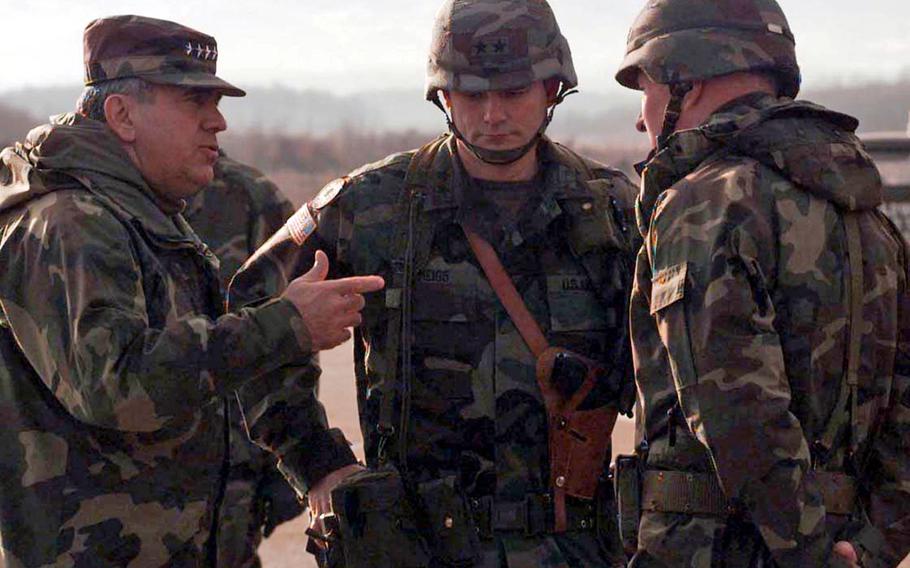 Montgomery Meigs, center, then a major general and the 1st Infantry Division commander, talks to Supreme Allied Commander Europe Gen. George Joulwan, left, and U.S. Army Europe commander Gen. William Crouch, at Tuzla Air Base in Bosnia, in 1996. Meigs was commanding Task Force Eagle at the time. Meigs died July 6, 2021, at age 76.         