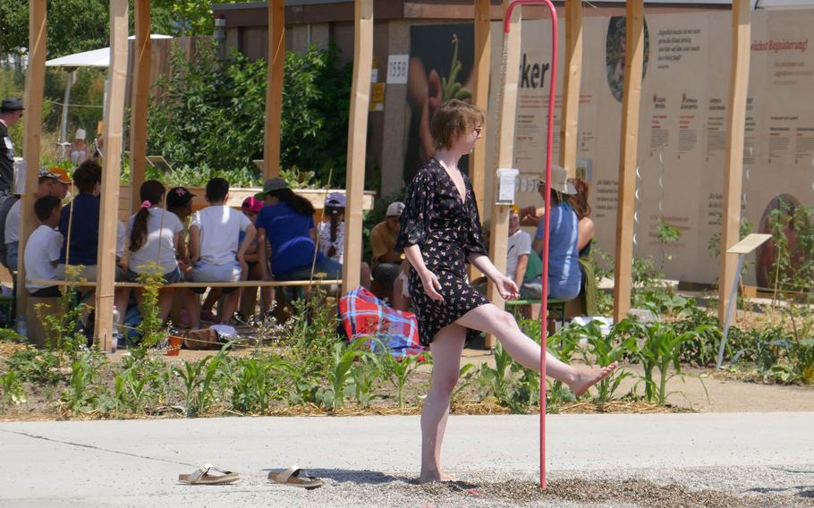 A visitor to the Bundesgartenschau, or BUGA, in Mannheim, Germany, cools her feet in a display that shows the sustainability of water in the garden. The German federal horticultural show runs until Oct. 8.