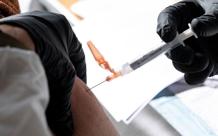 A healthcare worker administers a dose of the Moderna COVID-19 vaccine at a walk up vaccination site in San Francisco on Feb. 3, 2021. 
