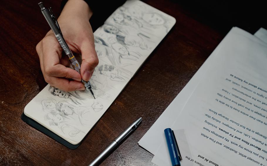 Karla Ortiz, a concept artist, illustrator and fine artist based in San Francisco, draws in her notebook before testifying at a Senate subcommittee hearing.