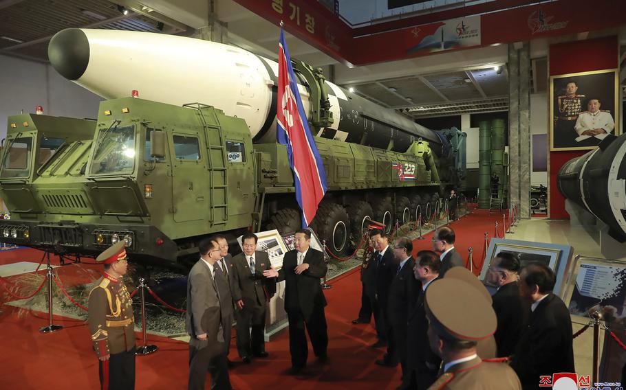 In this photo provided by the North Korean government, North Korean leader Kim Jong Un, center, speaks in front of what the North says an intercontinental ballistic missile displayed at an exhibition of weapons systems in Pyongyang, North Korea, Monday, Oct. 11, 2021. Independent journalists were not given access to cover the event depicted in this image distributed by the North Korean government. The content of this image is as provided and cannot be independently verified. Korean language watermark on image as provided by source reads: “KCNA” which is the abbreviation for Korean Central News Agency.