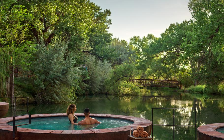 A couple soaks in the repose pools at Ojo Santa Fe.  The resort, located on 77 acres 20 minutes from the city, also has yoga classes, hiking trails and a spa, among its activities.