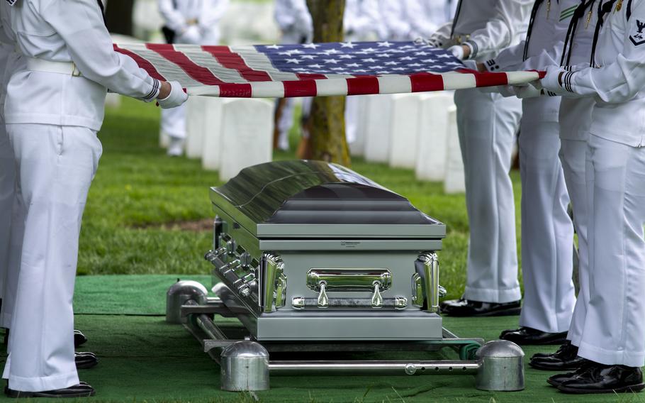 The U.S. Navy Ceremonial Guard holds an American flag over the casket of Starring Brooks Winfield in Arlington National Cemetery on May 9, 2024.