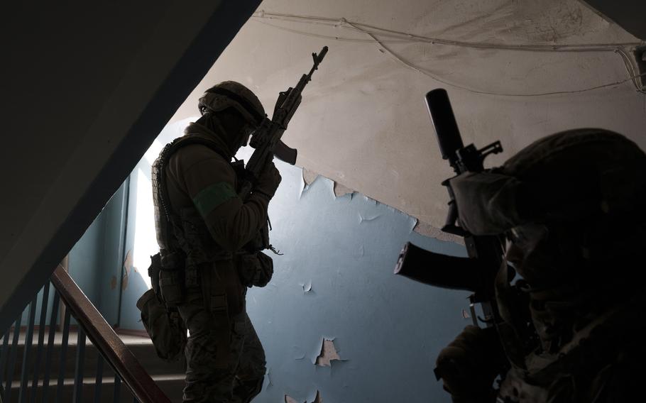 Security Service of Ukraine (SBU) servicemen enter a building during an operation to arrest suspected Russian collaborators in Kharkiv, Ukraine, Thursday, April 14, 2022. Ukrainian authorities are cracking down on anyone suspected of aiding Russian troops under laws enacted by Ukraine’s parliament and signed by President Volodymyr Zelenskyy after the Feb. 24 invasion. Offenders face up to 15 years in prison for acts of collaborating with the invaders or showing public support for them. 