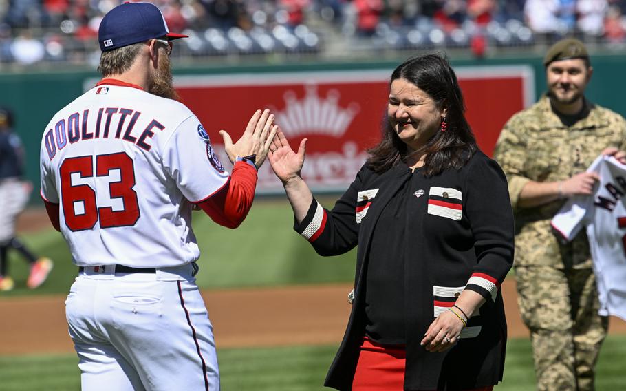Washington Nationals Sean Dolittle greets Ukraine Ambassador Oksana Markarova after she threw out the ceremonial first pitch during Opening Day at Nationals Park. 