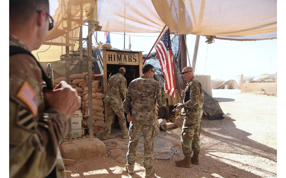 U.S. military officials enter a high-mobility artillery rocket system facility at the al-Tanf garrison in Syria on June 21., 2022.