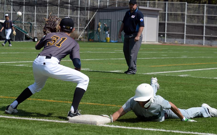 Kubasaki’s Max Ramos beats a pickoff throw to American School In Japan’s Billy Freund back to first base.
