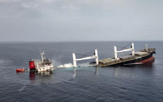A ship mostly submerged in the sea.
