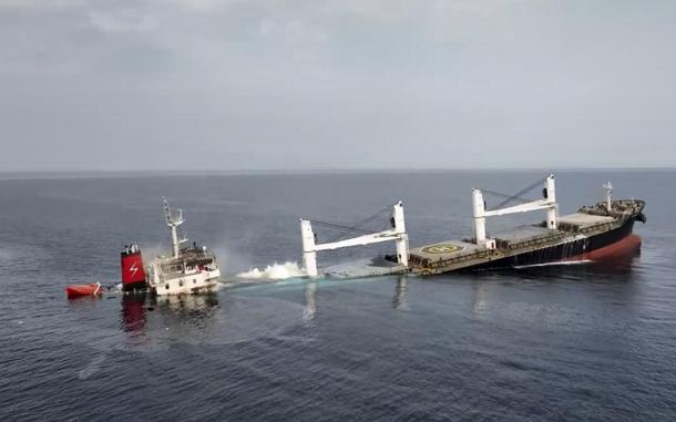 A ship mostly submerged in the sea.