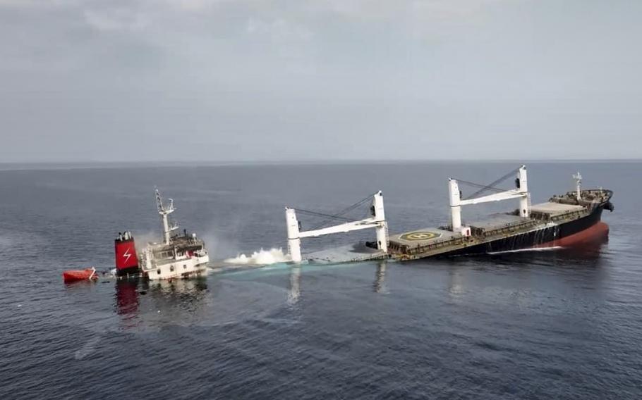 A ship mostly submerged in the sea.