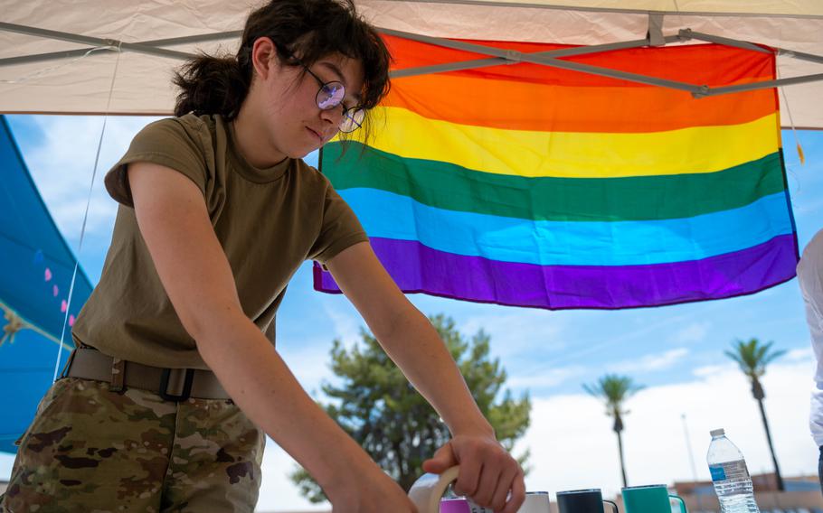 Air Force Airman 1st Class Ysabella Paris, a fuel maintenance technician, participates in a cardboard boat race event in honor of Pride Month on June 9, 2023, at Luke Air Force Base, Ariz.