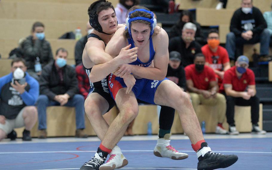 Jaden Workman of Hohenfels, left, beat Ramstein’s Evan Brooks for the 190-pound title at the high school 2022 Wrestling Tournament in Ramstein, Germany, Feb. 12, 2022.