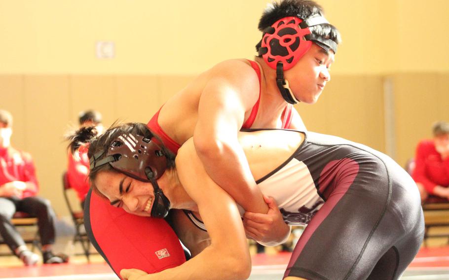 Matthew C. Perry's John Shaver and E.J. King's Raphael Catlin battle for position at 129 pounds during Saturday's DODEA-Japan wrestling dual meet. Shaver won by technical fall 16-4 in 1 minute, 50 seconds and the Samurai won the dual meet 37-27.